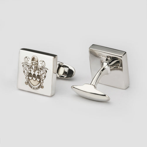 A pair of square cufflinks with a unique family crest engraved on them.